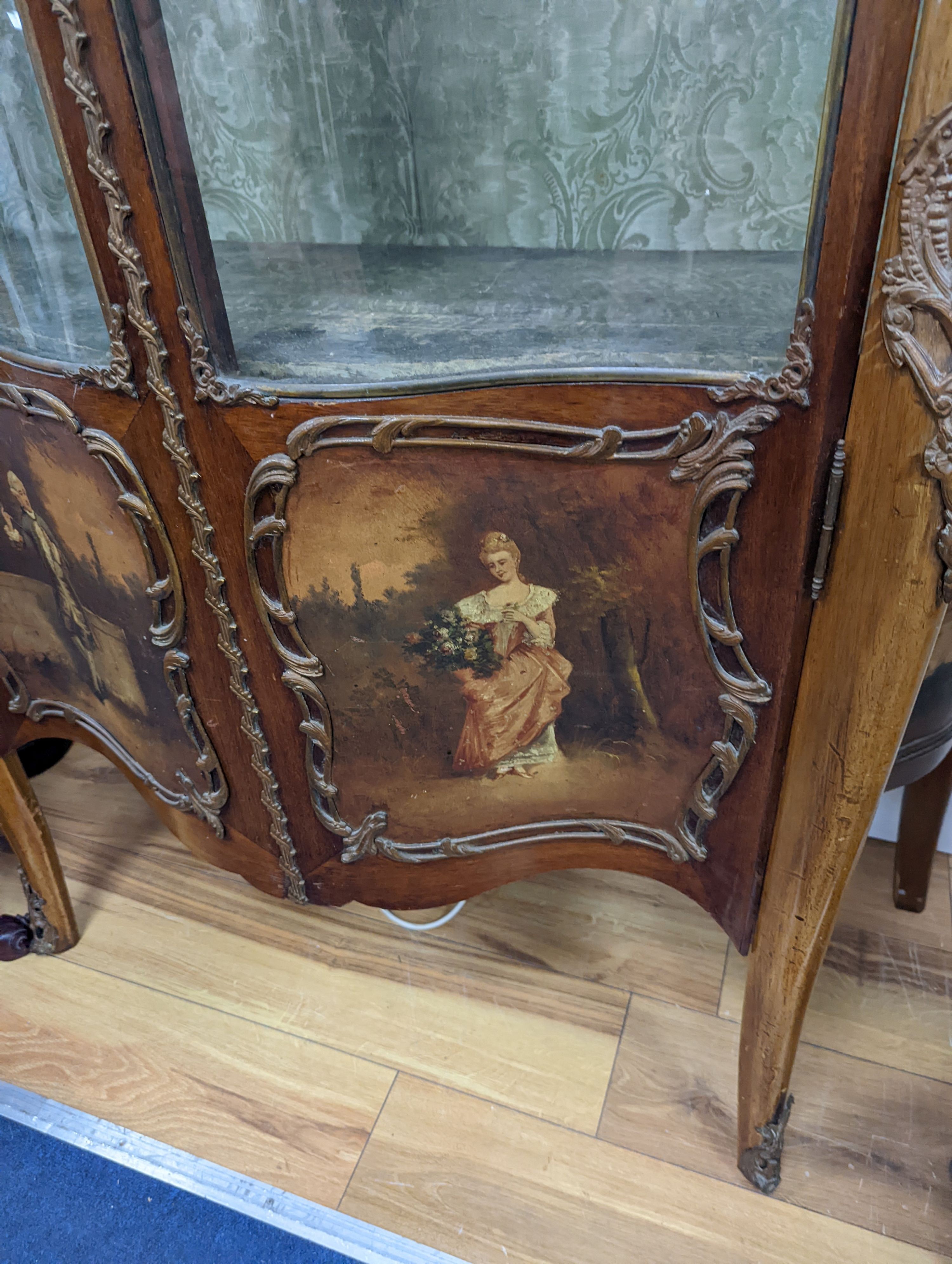 A Louis XV style mahogany serpentine vitrine with Vernis Martin style panels and gilt metal mounts, width 108cm, depth 46cm, height 193cm
